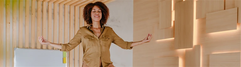 Kvinna på konferensbord står i yogapose