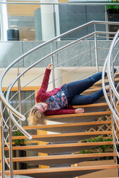 Kvinna faller i en trappa inomhus.