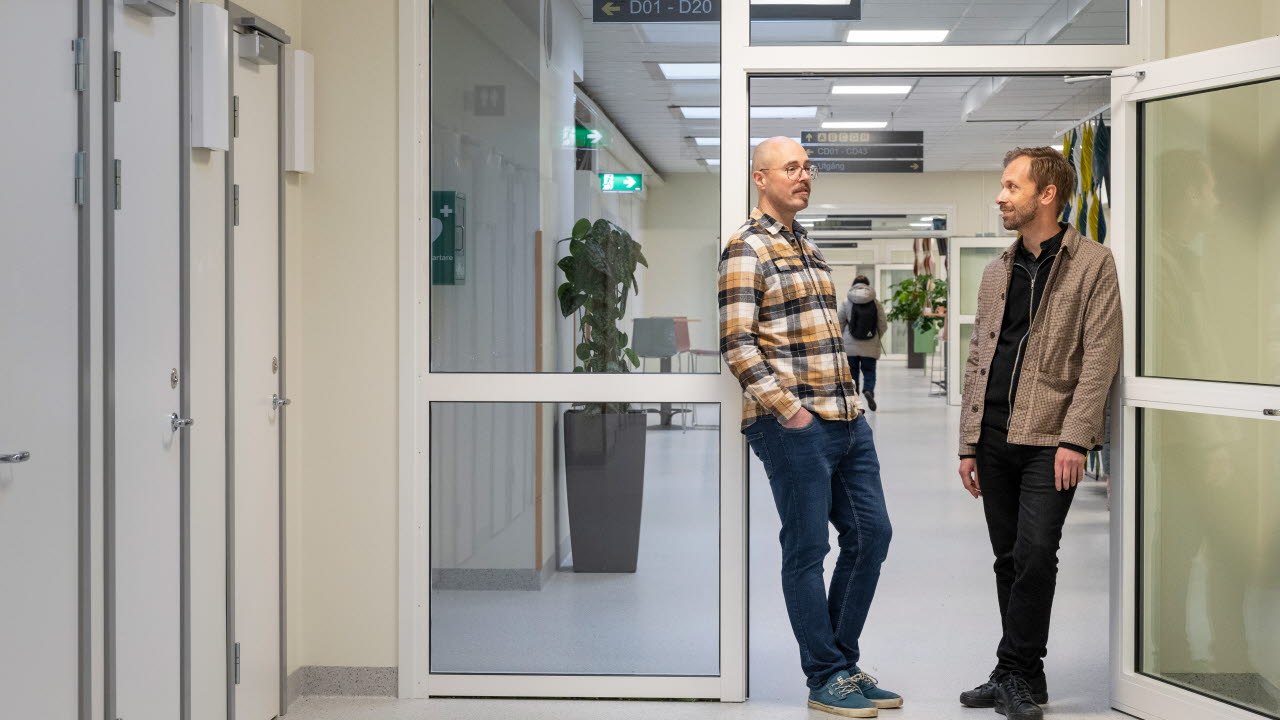 Petter Kraftling och Mattias Molin står och pratar i en korridor i Risbergska.