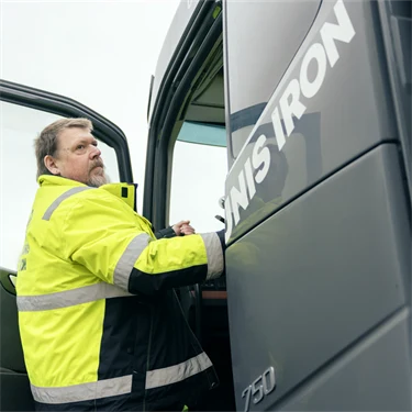 Ulrich Höntzcsch klättrar upp i hytten på en lastbil med tung last.